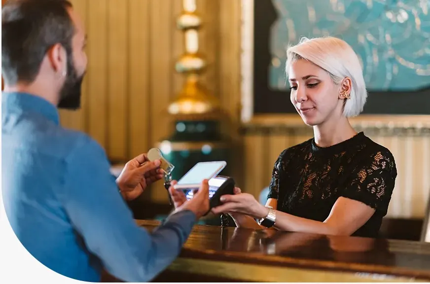 Card payment terminal being used at a hospitality counter