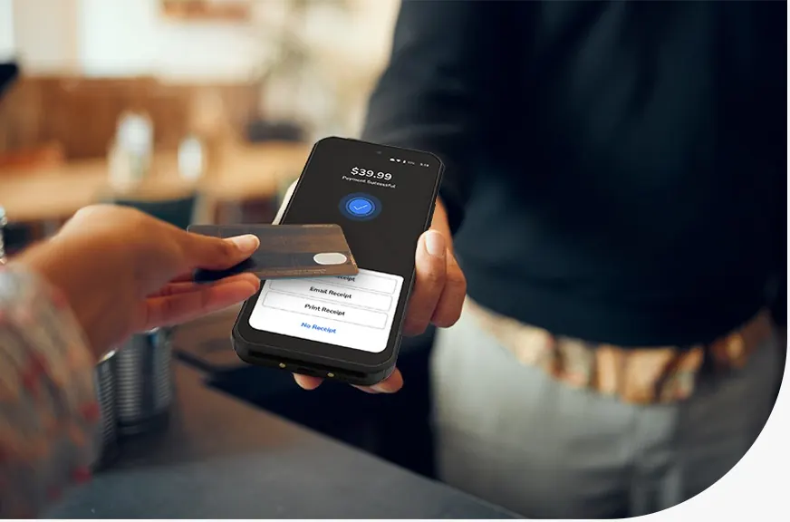 Customer paying by card using a handheld payment terminal